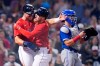 Boston Red Sox's Alex Verdugo, center, is congratulated by Hunter Renfroe, left, after his two-run home run in the eighth inning of a baseball game against the Toronto Blue Jays at Fenway Park, Monday, July 26, 2021, in Boston. Blue Jays catcher Reese McGuire, right, looks on. (AP Photo/Charles Krupa)