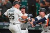 Seattle Mariners' Dylan Moore (25) is greeted by Tom Murphy, center, and Jarred Kelenic, right, after Moore hit a grand slam during the eighth inning of a baseball game against the Houston Astros, Monday, July 26, 2021, in Seattle. (AP Photo/Ted S. Warren)