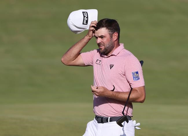Canada's Corey Conners acknowledges the crowd as her completes his third round on the 18th green at the British Open Golf Championship at Royal St George's golf course Sandwich, England, Saturday, July 17, 2021. THE CANADIAN PRESS/AP/Ian Walton