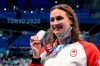 Canada's Kylie Masse poses with her silver medal won in the women's 100m backstroke final event during the Tokyo Summer Olympic Games, in Tokyo, Tuesday, July 27, 2021. THE CANADIAN PRESS/Frank Gunn