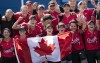 Canada’s women’s softball team pose for a photo with the Canadian flag after their win over Mexico in the bronze medal game at the Tokyo Olympics, Tuesday, July 27, 2021 in Yokohama, Japan. THE CANADIAN PRESS/Adrian Wyld