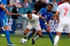 Canada defender Mark-Anthony Kaye (14) and Martinique midfielder Romario Barthelery (22) chase the ball during the first half of a CONCACAF Gold Cup soccer match on July 11, 2021, in Kansas City, Kan. THE CANADIAN PRESS/AP, Charlie Riedel