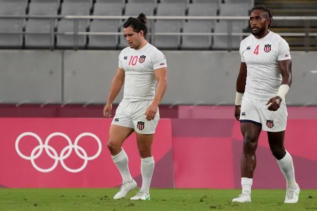 Madison Hughes, left, of the United States and teammate Matai Leuta react after the U.S. team lost to Britain in their men's rugby sevens quarterfinal match at the 2020 Summer Olympics, Tuesday, July 27, 2021, in Tokyo. (AP Photo/Shuji Kajiyama)