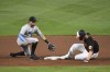 Baltimore Orioles' Trey Mancini avoids the tag from Miami Marlins shortstop Miguel Rojas and slides into second base for a double during the fourth inning of a baseball game Tuesday, July 27, 2021, in Baltimore. (AP Photo/Terrance Williams)