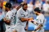 Chicago White Sox's Eloy Jimenez, center, celebrates with Tim Anderson (7) and Leury Garcia (28) at the end of the team's baseball game against the Kansas City Royals at Kauffman Stadium in Kansas City, Mo., Tuesday, July 27, 2021. (AP Photo/Colin E. Braley)