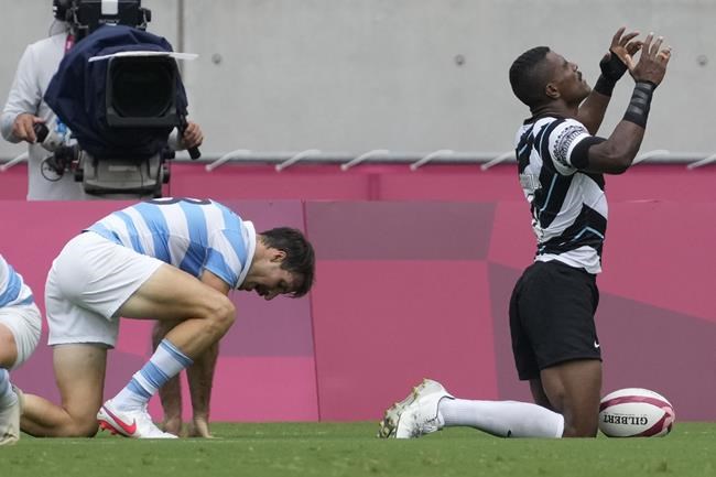 Fiji's Jiuta Wainiqolo celebrates after scoring a try, in Fiji's men's rugby sevens semifinal match against Argentina, at the 2020 Summer Olympics, Wednesday, July 28, 2021 in Tokyo, Japan. (AP Photo/Shuji Kajiyama)