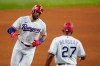 Texas Rangers' Joey Gallo, left, celebrates with third base coach Tony Beasley (27) after hitting a three-run home run off of Arizona Diamondbacks' Taylor Widener during the fourth inning of a baseball game in Arlington, Texas, Tuesday, July 27, 2021. (AP Photo/Tony Gutierrez)