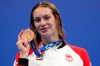 Penny Oleksiak of Canada holds up her bronze medal from the women's 200-meter freestyle final at the 2020 Summer Olympics, Wednesday, July 28, 2021, in Tokyo, Japan. THE CANADIAN PRESS/AP/Matthias Schrader