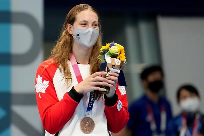 Canada's Penny Oleksiak stands with her bronze medal won in the women's 200m freestyle final event during the Tokyo Summer Olympic Games, in Tokyo, Wednesday, July 28, 2021. THE CANADIAN PRESS/Frank Gunn