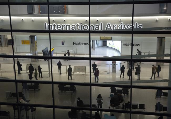 FILE - In this file photo dated Tuesday, Jan. 26, 2021, people in the International Arrivals area at Heathrow Airport in London, during England's coronavirus lockdown. The British government has said that starting upcoming Monday Aug. 2, 2021, fully vaccinated travellers from the United States and much of Europe will be able to enter England without the need for quarantining. (AP Photo/Matt Dunham, FILE)