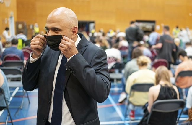 Britain's Health Secretary Sajid Javid speaks to the media during a visit to a pop-up vaccination site at a sports centre in west London, Wednesday July 28, 2021. The British government has said that starting upcoming Monday Aug. 2, 2021, fully vaccinated travellers from the United States and much of Europe will be able to enter England without the need for quarantining.(Dominic Lipinski/PA via AP)