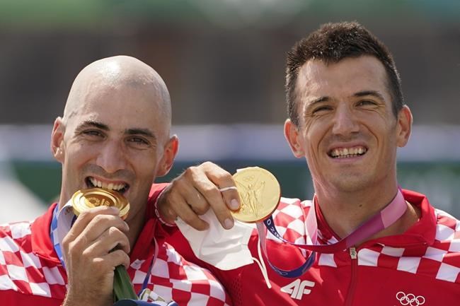Martin Sinkovic and Valent Sinkovic of Croatia pose with the gold medal in the men's rowing pair final at the 2020 Summer Olympics, Thursday, July 29, 2021, in Tokyo, Japan. (AP Photo/Darron Cummings