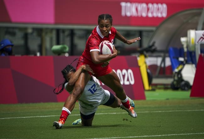 Canada's Keyara Wardley (12) attempts to break a tackle by Brazil's Thalita da Silva Costa (12) during preliminary-round rugby action during the Tokyo Summer Olympic Games Thursday, July 29, 2021. THE CANADIAN PRESS/HO, COC, Leah Hennel *MANDATORY CREDIT*