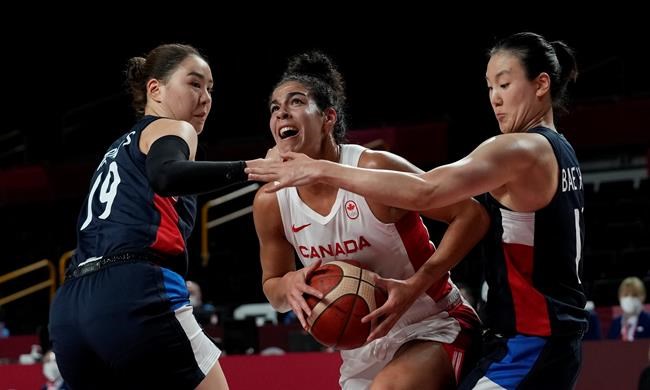 Canada's Kia Nurse (5), centre, drives between South Korea's Ji Su Park (19), left, and Hyeyoon Bae (11) during women's basketball preliminary round action at the Tokyo Summer Olympic Games, in Saitama, Japan, Thursday, July 29, 2021. THE CANADIAN PRESS/AP-Eric Gay