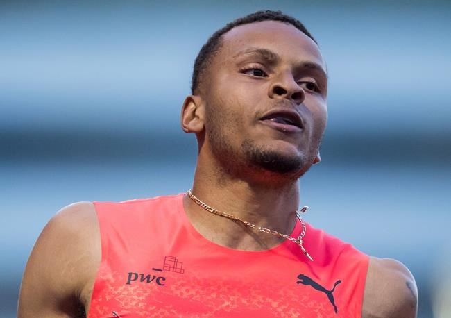 Andre De Grasse, left, of Toronto, sprits to a third-place finish during the Canada-China challenge men's 100 metre race at the Harry Jerome International Track Classic, in Burnaby, B.C., on Tuesday, June 26, 2018. THE CANADIAN PRESS/Darryl Dyck