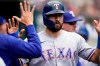 Texas Rangers designated hitter Joey Gallo is greeted in the dugout after scoring during the fourth inning of a baseball game against the Detroit Tigers, Thursday, July 22, 2021, in Detroit. (AP Photo/Carlos Osorio)