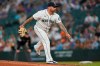 Seattle Mariners pitcher Hector Santiago watches a delivery during the fifth inning of the team's baseball game against the Houston Astros, Tuesday, July 27, 2021, in Seattle. It was the first game back for Santiago after he served a 10-game suspension for violating MLB's rules for foreign substances that could aid in pitching. (AP Photo/Ted S. Warren)