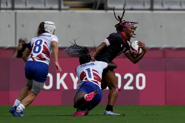 Canada's Charity Williams is tackled by France's Seraphine Okemba, in their women's rugby sevens match at the 2020 Summer Olympics, Friday, July 30, 2021 in Tokyo, Japan. (AP Photo/Shuji Kajiyama)