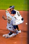 Milwaukee Brewers' Tyrone Taylor (15) slides safely into second with an RBI double as the relay throw gets past Pittsburgh Pirates second baseman Rodolfo Castro during the sixth inning of a baseball game in Pittsburgh, Thursday, July 29, 2021. (AP Photo/Gene J. Puskar)