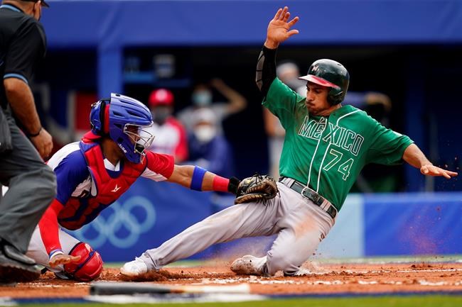 Mexico's Isaac Rodriguez, right, is tagged out at home plate by Dominican Republic's Charlie Valerio during a baseball game at Yokohama Baseball Stadium during the 2020 Summer Olympics, Friday, July 30, 2021, in Yokohama, Japan. (AP Photo/Matt Slocum)