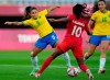 Brazil's Debinha, left, battles with Canada's Ashley Lawrence during a women's quarterfinal soccer match at the Tokyo Summer Olympic Games,&nbsp;in Rifu, Japan, Friday, July 30, 2021. Canada beat Brazil 4-3 on penalty kicks Friday to advance to the semifinals of the Olympic women's soccer tournament. THE CANADIAN PRESS/AP-Andre Penner