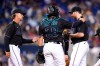 Miami Marlins manager Don Mattingly, left goes to the mound to remove starting pitcher Zach Thompson, right, during the sixth inning of the team's baseball game against the New York Yankees, Friday, July 30, 2021, in Miami. At center is catcher Jorge Alfaro (38). (AP Photo/Lynne Sladky)