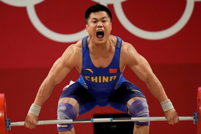 Lyu Xiaojun of China competes in the men's 81kg weightlifting event, at the 2020 Summer Olympics, Saturday, July 31, 2021, in Tokyo, Japan. (AP Photo/Luca Bruno)