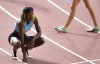 FILE - In this Oct. 3, 2019, file photo, Shaunae Miller-Uibo, of Bahamas, looks at the scoreboard after winning silver in the women's 400-meter final at the World Athletics Championships in Doha, Qatar. Miller-Uibo won gold in Rio with a dive at the finish of the 400 meters. She's diving in at the Tokyo Games with plans to not only defend her title but chase after gold in the 200 meters. (AP Photo/Martin Meissner, File)