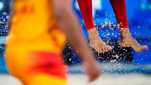 Feet and sand fly during the beach volleyball match between Norway and Spain at the 2020 Summer Olympics, Monday, July 26, 2021, in Tokyo, Japan. (AP Photo/Petros Giannakouris)