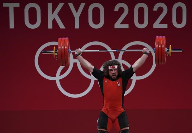 Canada's Boady Santavy competes in the Men’s 96kg Weightlifting finals during the Tokyo Summer Olympic Games, in Tokyo on Saturday, July 31, 2021. Santavy lifted a combined 386 kilograms to take fourth on Saturday in the 96-kilogram weight class at the Tokyo Olympics. THE CANADIAN PRESS/Nathan Denette