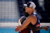 Cherif Younousse, left, of Qatar, hugs Philip Dalhausser, of the United States, after Qatar won a men's beach volleyball match at the 2020 Summer Olympics, Sunday, Aug. 1, 2021, in Tokyo, Japan. (AP Photo/Felipe Dana)
