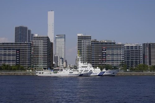 Japanese Coast Guard boats dock in Tokyo Bay outside of the Olympic athletes' village ahead of the 2020 Summer Olympics, Monday, July 19, 2021, in Tokyo. (AP Photo/Charlie Riedel)