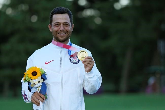Xander Schauffele, of the United States, holds his gold medal in the men's golf at the 2020 Summer Olympics on Sunday, Aug. 1, 2021, in Kawagoe, Japan. (AP Photo/Andy Wong)