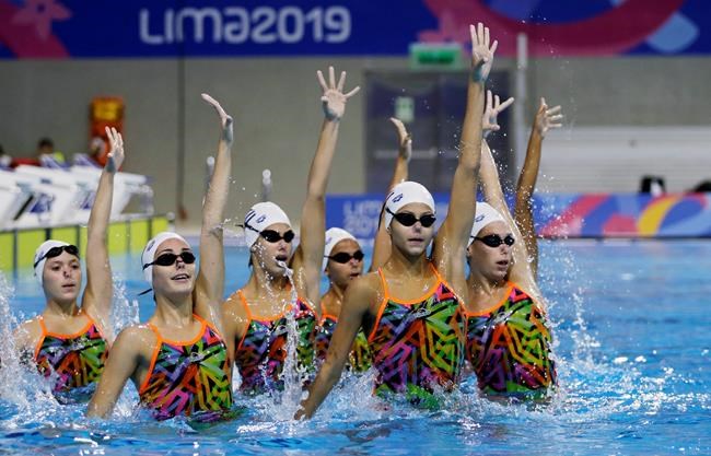 FILE - In this July 25, 2019, file photo, the synchronized swimming team of Cuba performs their routine during a training session at the Pan Am Games in Lima, Peru. Forget boxing or rugby. The most hardcore sport at the Tokyo Games may just be artistic swimming. The sport once known as synchronized swimming has rapidly evolved into one of the most physically grueling specialties at the Olympics. (AP Photo/Fernando Vergara, File)