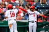 Washington Nationals' Josh Bell (19) is greeted by Luis Garcia (2) as he scores on a single by Yadiel Hernandez during the third inning of a baseball game against the Chicago Cubs, Sunday, Aug. 1, 2021, in Washington. (AP Photo/Nick Wass)