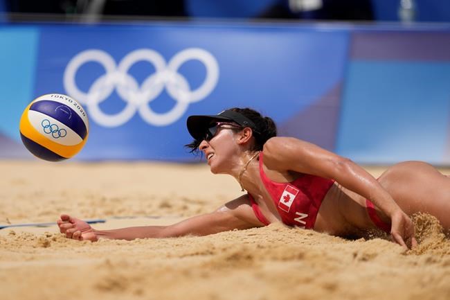 Melissa Humana-Paredes, of Canada digs out the ball during a women's beach volleyball match against Spain at the 2020 Summer Olympics, Monday, Aug. 2, 2021, in Tokyo, Japan. (AP Photo/Petros Giannakouris)