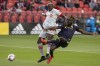 Toronto FC's Chris Mavinga (left) fends off Nashville SC's C.J. Sapong during first half MLS  action in Toronto on Sunday, August 1, 2021. THE CANADIAN PRESS/Chris Young