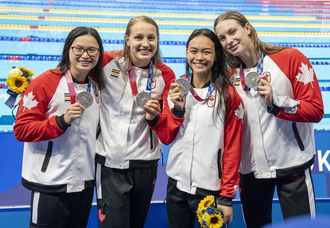 Canada's Margaret Mac Neil, Rebecca Smith, Kayla Sanchez and Penny Oleksiak show off their silver medals from the women's 4 x 100m freestyle relay during the Tokyo Olympics in Tokyo, Japan on July 25, 2021. THE CANADIAN PRESS/ Frank Gunn