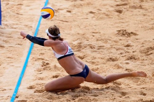 April Ross, of the United States, dives for a shot during a women's beach volleyball match against Germany at the 2020 Summer Olympics, Tuesday, Aug. 3, 2021, in Tokyo, Japan. (AP Photo/Felipe Dana)