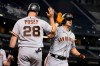 San Francisco Giants' Alex Dickerson, right, celebrates with Buster Posey (28) after hitting a grand slam against the Arizona Diamondbacks in the fifth inning during a baseball game, Monday, Aug 2, 2021, in Phoenix. (AP Photo/Rick Scuteri)