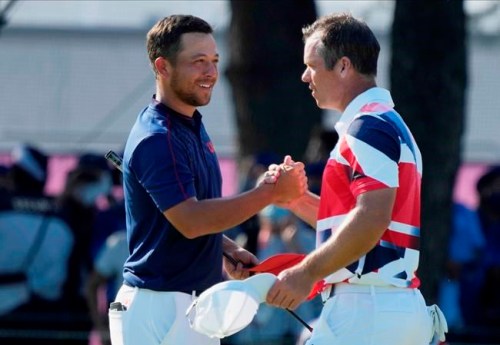 CORRECTS LAST NAME TO SCHAUFFELE FROM SHAUFFELE - Xander Schauffele of the United States, left, is congratulated by Paul Casey of Britain after winning gold in the men's golf event at the 2020 Summer Olympics on Sunday, Aug. 1, 2021, in Kawagoe, Japan. (AP Photo/Andy Wong)