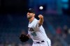 Arizona Diamondbacks starting pitcher Madison Bumgarner throws to a San Francisco Giants batter during the first inning of a baseball game Tuesday, Aug. 3, 2021, in Phoenix. (AP Photo/Ross D. Franklin)