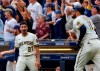 Milwaukee Brewers' Willy Adames(27) reacts to Rowdy Tellez' , right, three-RBI pinch hit home run against the Pittsburgh Pirates during the seventh inning of a baseball game Wednesday, Aug. 4, 2021, in Milwaukee. (AP Photo/Jeffrey Phelps)