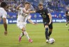 CF Montreal midfielder Djordje Mihailovic fends off Atlanta United Amar Sejdic during first-half MLS action in Montreal on Wednesday, August 4, 2021. THE CANADIAN PRESS/Paul Chiasson