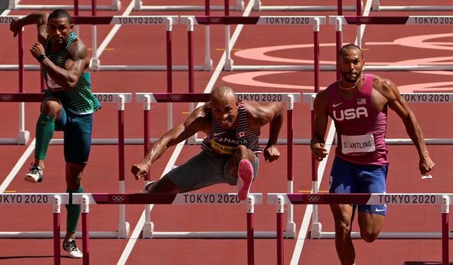 Damian Warner of Canada clears a hurdle alongside Garrett Scantling, of United States in a heat of the decathlon men's 110-metre hurdles at the 2020 Summer Olympics, Thursday, Aug. 5, 2021, in Tokyo, Japan. THE CANADIAN PRESS/AP-Charlie Riedel