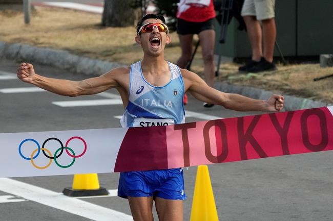Massimo Stano, of Italy, crosses the finish line to win the men's 20km race walk at the 2020 Summer Olympics, Thursday, Aug. 5, 2021, in Sapporo, Japan. (AP Photo/Shuji Kajiyama)