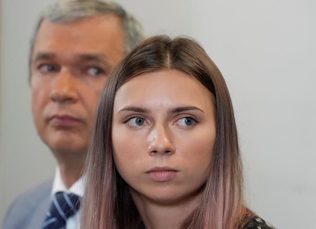 Belarusian dissident in Poland, Pavel Latushka, left, and Belarusian Olympic sprinter Krystsina Tsimanouskaya, right, who came to Poland fearing reprisals at home after criticizing her coaches at the Tokyo Games, talk to journalists in Warsaw, Poland, Thursday, Aug. 5, 2021. (AP Photo/Czarek Sokolowski)