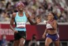 Shaunae Miller-Uibo, of Bahamas crosses the line to win the gold medal ahead of Allyson Felix, of United States, bronze, in the final of women's 400-meters at the 2020 Summer Olympics, Friday, Aug. 6, 2021, in Tokyo, Japan. (AP Photo/Charlie Riedel)