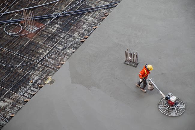 A worker smooths concrete at a construction site in Toronto, Thursday, Jan. 16, 2020. THE CANADIAN PRESS/Cole Burston
