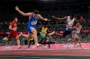 Filippo Tortu, of Italy, crosses the finish line ahead of Nethaneel Mitchell-Blake, of Britain, to lead his to team a gold medal in the men's 4x100-meter relay at the 2020 Summer Olympics, Friday, Aug. 6, 2021, in Tokyo. (AP Photo/David J. Phillip)